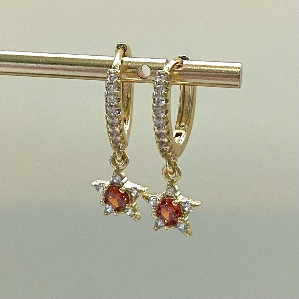 Gold star earrings with orange gemstone
